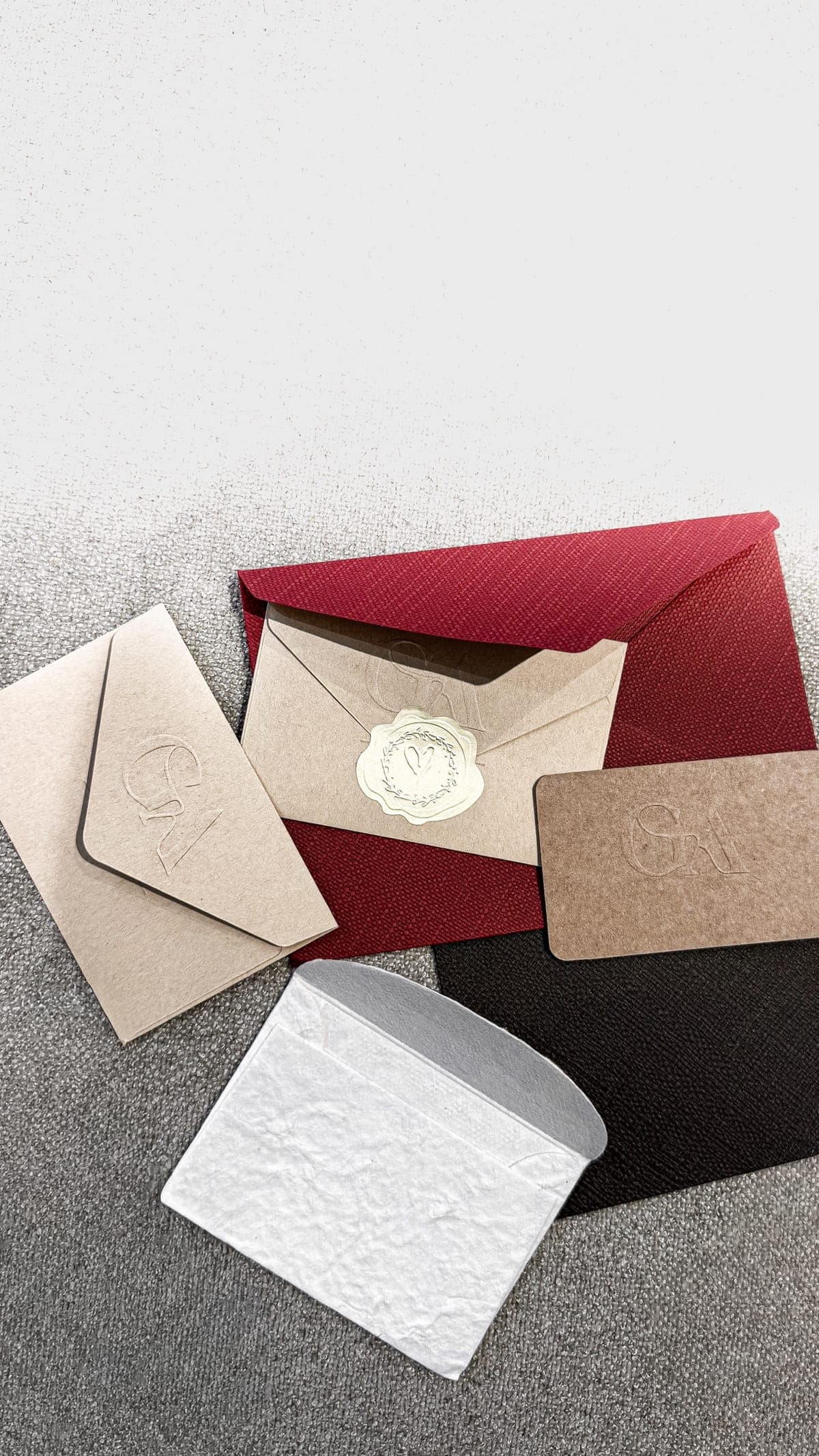 GYAN gift cards in kraft paper with embossed GA monogram, envelopes and a wax seal